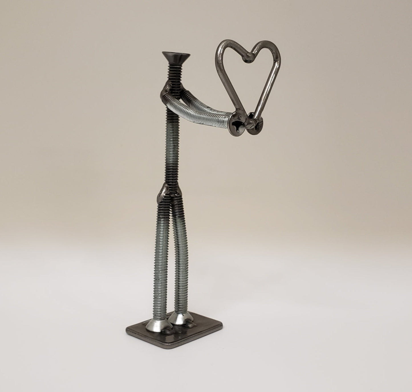 Metal figure holding heart
