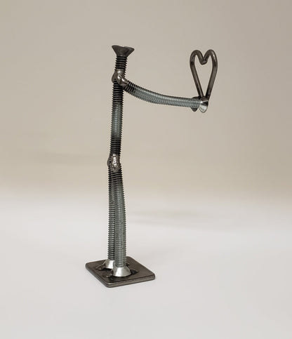 Metal figure holding heart