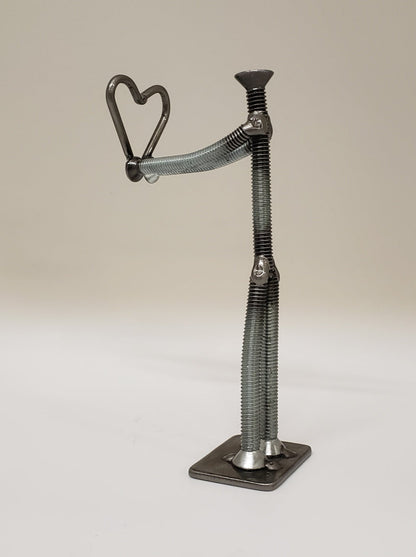 Metal figure holding heart