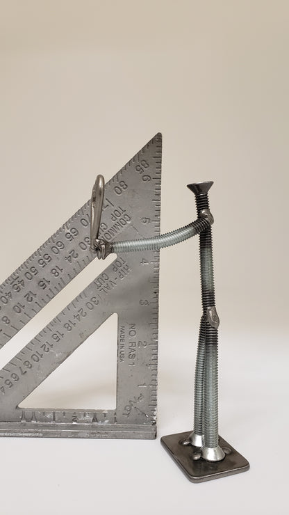 Metal figure holding heart