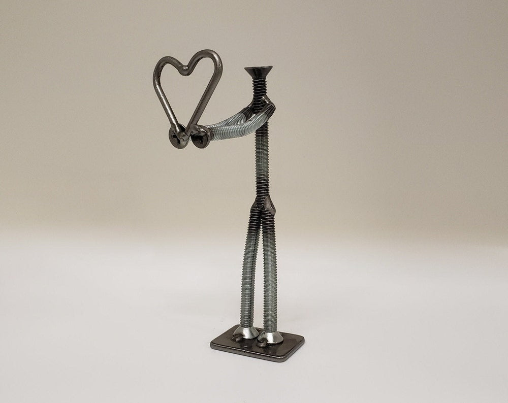 Metal figure holding heart